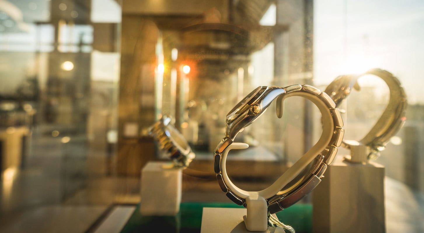 A jewelry store window showcasing an elegant array of watches, highlighting various styles and designs for potential customers.