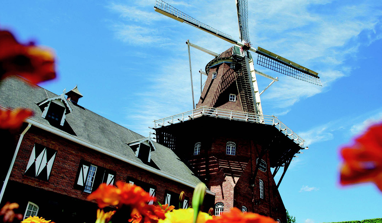 A large building featuring a prominent windmill atop its roof.